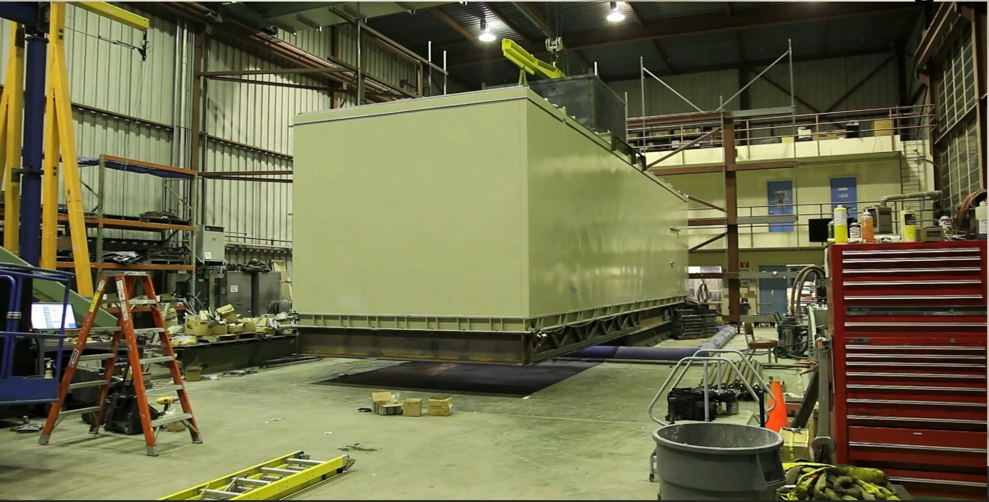 Full-size containerized genset enclosure mounted on shake table test platform